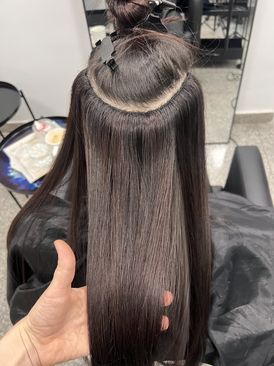 Weft extensions being fitted to hair